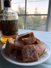 a white plate with a bottle of whisky on it