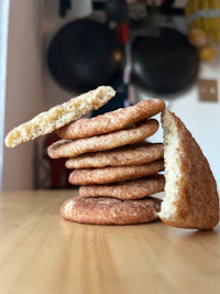 a stack of cinnamon cookies on a wooden table