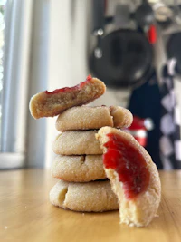 a stack of cookies with jam on top