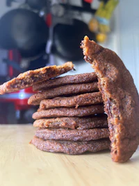 a stack of chocolate chip cookies on a table